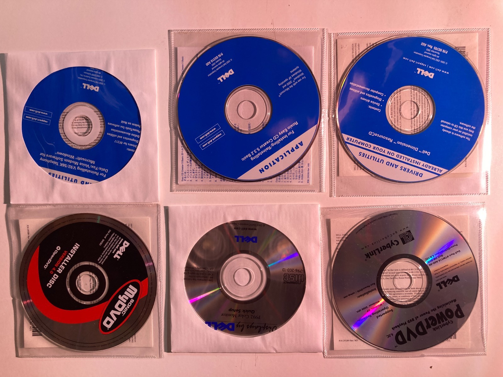 Six (6) - 2002 Dell Installation Discs; Drivers & Utilities; Roxio; CyberLink;