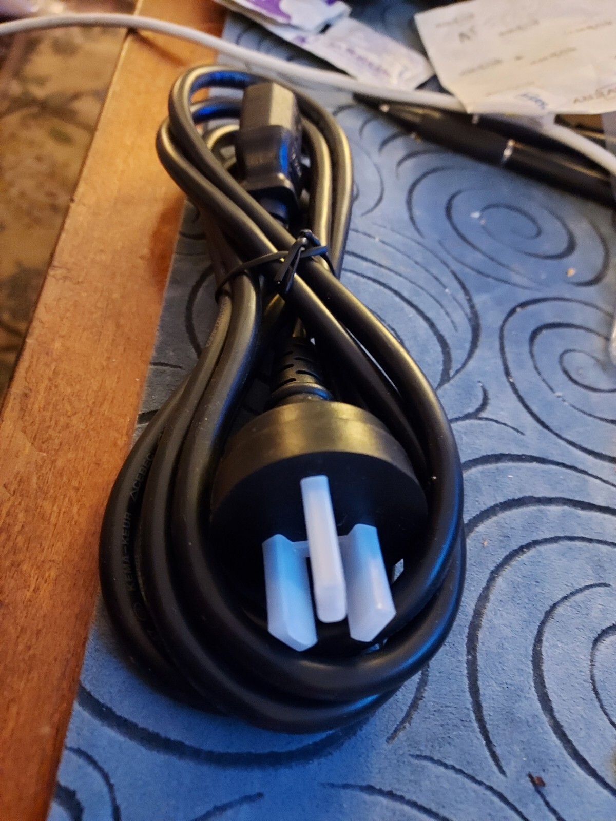 COMPUTER CORD WITH A 3 PRONG END WITH 3 FLAT PINS IN A TRIANGLE